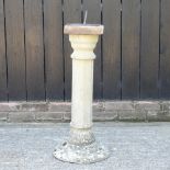 A reconstituted stone sun dial, on a fluted column,