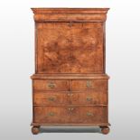 An 18th century and later walnut escritoire, having a fitted interior, enclosed by a hinged fall,