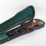 An antique violin, bearing a label for Louis Joly, Mirecourt, 14" body, with a bow,