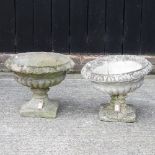 A pair of reconstituted stone pedestal planters,