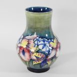 An early 20th century Moorcroft pottery vase, of baluster shape, decorated in the Iris pattern,