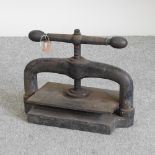 An antique cast iron book press,