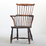 A 19th century elm seated comb back armchair,