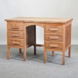 A 1920's light oak desk,