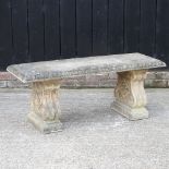 A reconstituted stone garden bench,