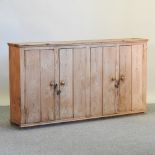An antique pine side cabinet,