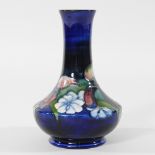 An early 20th century Moorcroft pottery vase, decorated with flowers,