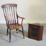 An early 20th century elm seated splat back armchair, together with a glazed hanging corner cabinet,