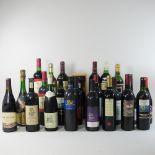 A collection of twenty-four bottles of various wines, mainly red table wine,