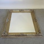 A large ornate gilt painted wall mirror,
