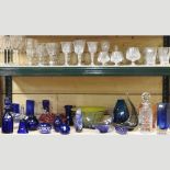 Two shelves of cut and coloured glassware,