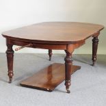 A Victorian mahogany extending dining table, with two additional leaves,