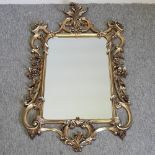 A Rococo style gilt framed wall mirror,