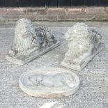 A pair of reconstituted stone models of recumbent lions, each 50cm long,
