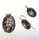 A black enamel, seed pearl and diamond set oval pendant,