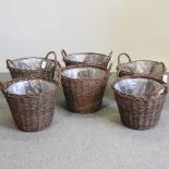 A set of six circular wicker log baskets,