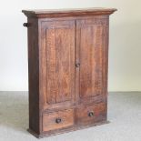 A 19th century oak hanging cabinet,