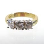 A large 18 carat gold three stone diamond ring, approximately 2.