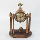 An early 20th century walnut cased portico clock, 21cm, together with The Clock Repairers Handbook,