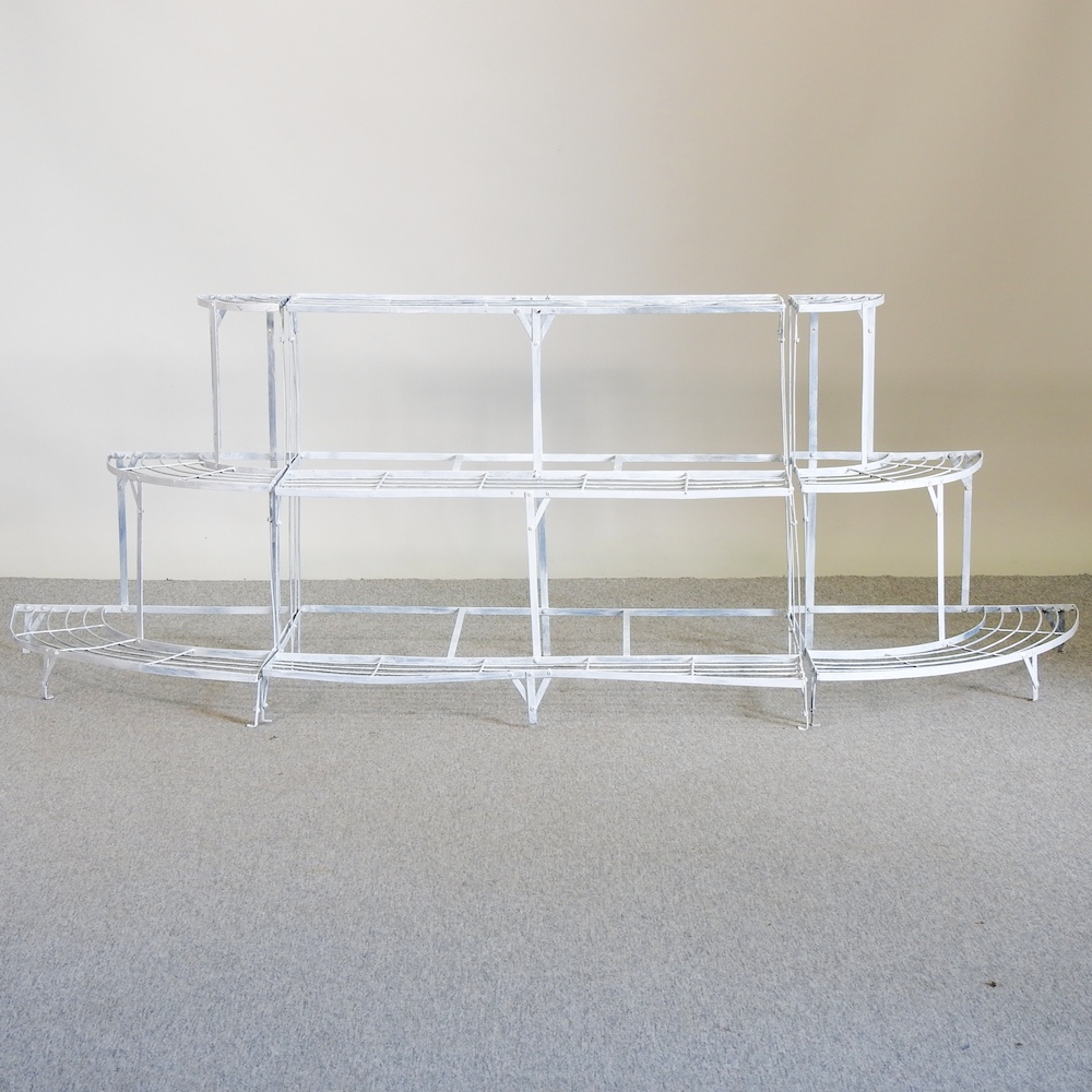 A white painted iron three tier graduated plant stand,