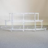 A white painted iron three tier graduated plant stand,