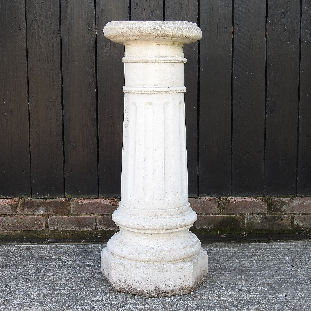 A reconstituted stone fluted column,