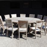 A large teak circular garden table, 220cm diameter,