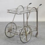 A mid 20th century brass effect and glass hostess trolley,