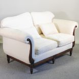 A pair of cream upholstered two seater scroll end sofas,