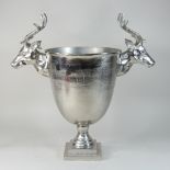 A metal wine cooler, decorated with stags,