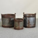 A set of three metal milk pails,