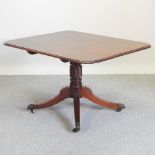 A Regency mahogany dining table, having a hinged rectangular top,
