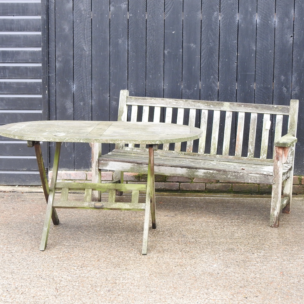 A teak slatted garden bench, 160cm, together with a folding garden table,