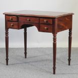 A 19th century writing table, containing five drawers, on turned legs,