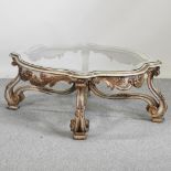 A continental painted coffee table, with a shaped glass top,
