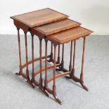 A nest of three early 20th century satinwood and mahogany occasional tables, on ring turned legs,