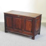 An 18th century oak coffer, with a hinged lid,