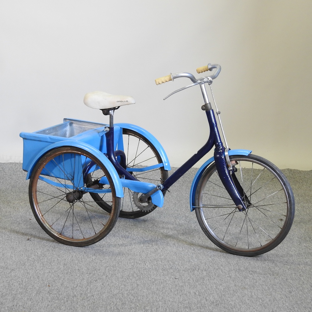 A vintage blue painted child's tricycle