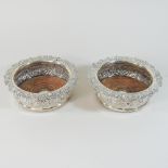 A pair of William IV silver wine coasters, each of circular shape,