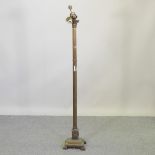 A brass standard lamp, in the form of a corinthian column,