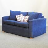 A modern blue upholstered two seater sofa,