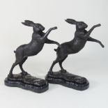 A pair of modern bronze models of boxing hares,