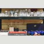 Two shelves of drinking glasses,