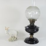A brass hanging oil lantern with a glass shade,