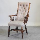An early 20th century green and pink upholstered Windsor style armchair