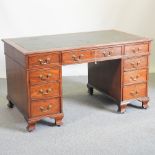 An early 20th century mahogany partners' desk, with a green inset writing surface,