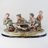 A large Capodimonte figure group of boys playing cards,
