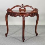 A hardwood bow front side table, on cabriole legs,