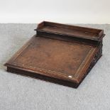 A 19th century heavily carved dark oak clerks desk, with a hinged sloping fall,