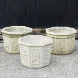 A set of three reconstituted stone octagonal garden planters,